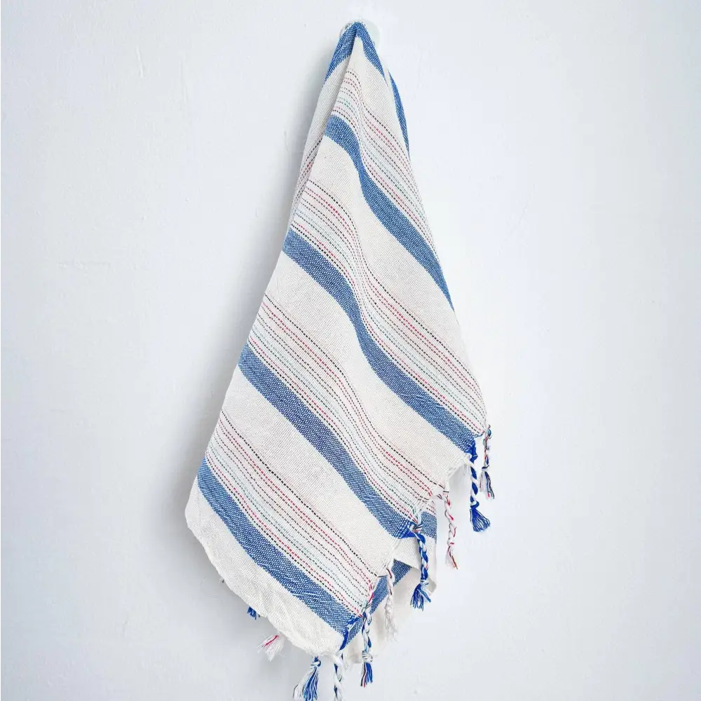 Blue and ivory striped hand woven Turkish hand towel with thin lines of red stripes.
