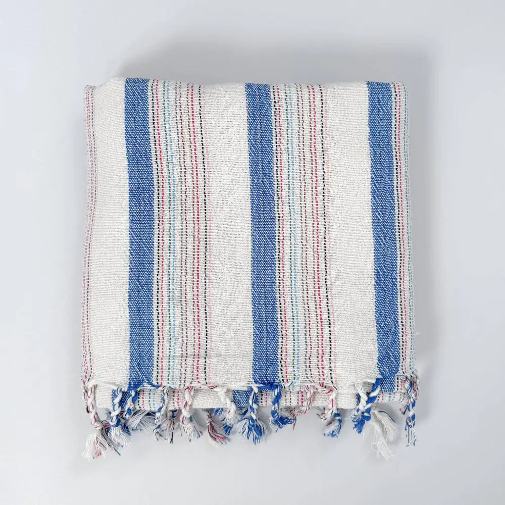 Blue and ivory striped hand woven Turkish hand towel with thin red stripes.