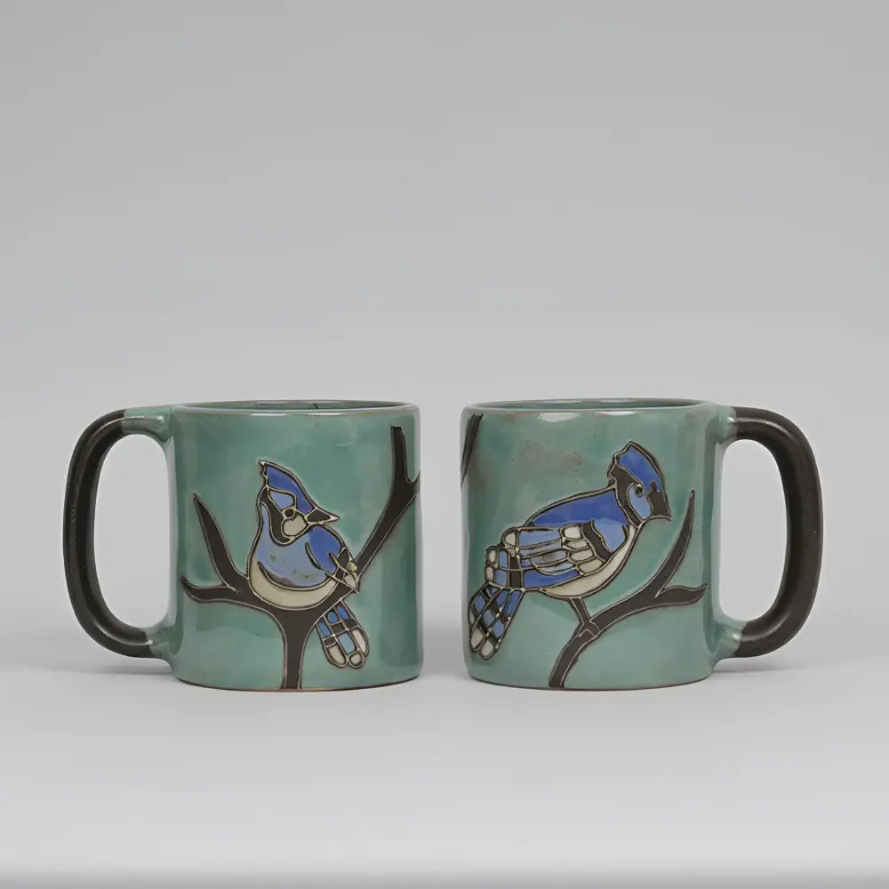 Two Mara Ceramica artisans teal mugs with hand-painted blue jay
