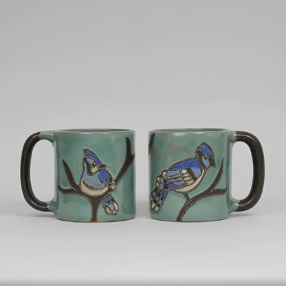 Two Mara Ceramica artisans teal mugs with hand-painted blue jay