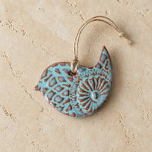 Turquoise and brown ceramic bluebird ornament with embossed patterns perfect for bird lovers and precious bird ornaments