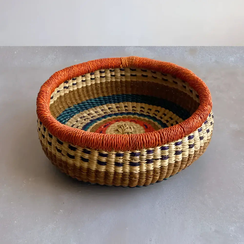 round basket with bright colors on a gray surface