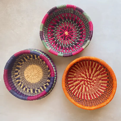 top view of the inside of three colorful round baskets