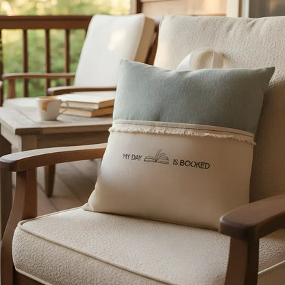 Handcrafted beige and light blue Bookworm Nest reading pillow with my day is booked embroidery