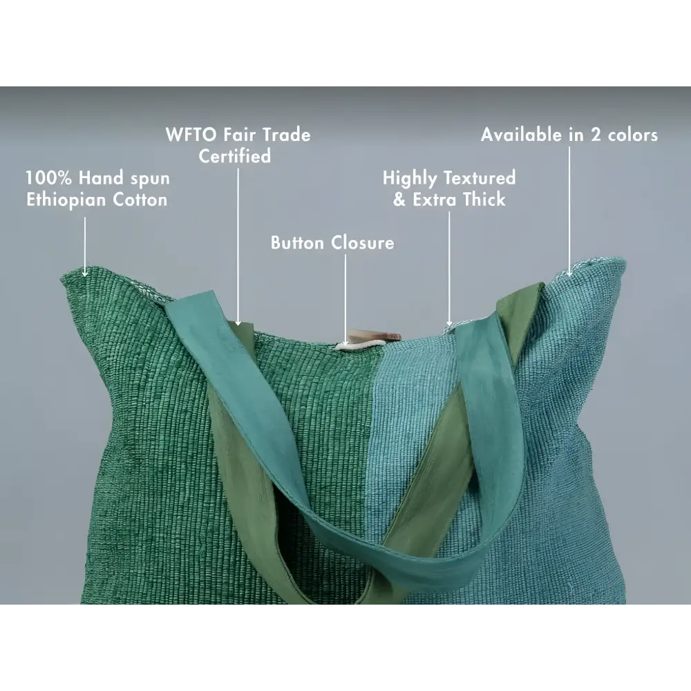 A handwoven borsa tote bag made from 100 percent ethiopian cotton with textured thick weave and teal straps