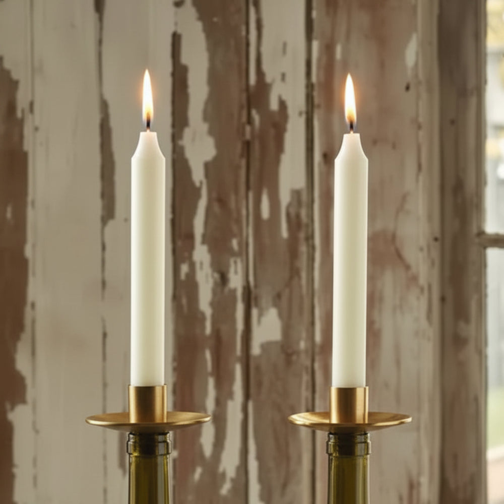 A colorful collection of eco-friendly handmade glass wine bottle candle holders with metallic rims called bottelabra taper gold