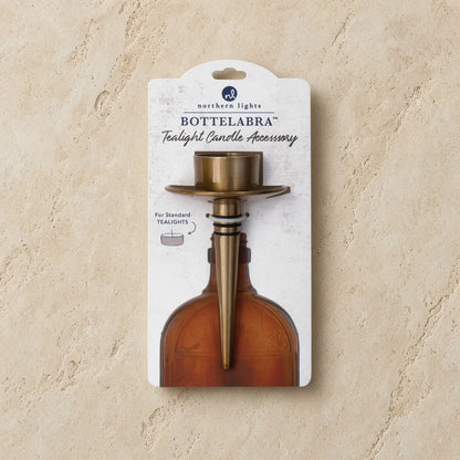 Brass-colored bottelabra™ tealight holder with flared top and tapered stem to transform empty bottles elegantly