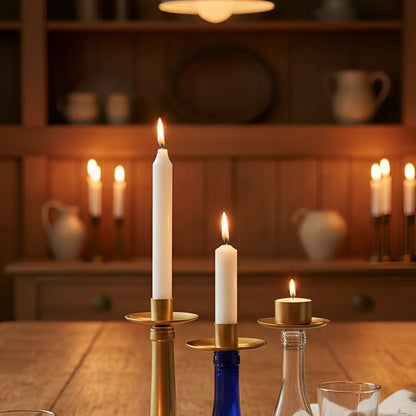 White taper candles in brass Bottelabra elegant candelabras securely transform empty blue and clear glass bottles with rubber rings