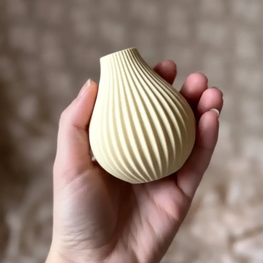 Cream-colored ceramic vase with vertical ribbed texture and tapered neck in dried floral bouquet gift set by boyds custom fabrication