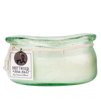 A translucent green bubble glass candle jar with a light soy candle labeled driftwood plus sea salt by nl in the candle collection