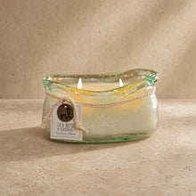Seafoam green bubble glass candle holder with two lit candles from the bubble glass candle collection sea rose + cotton