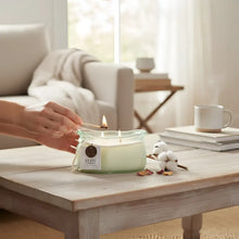 Green glass jar candle with cotton branch and wooden wick from Bubble Glass Candle Collection