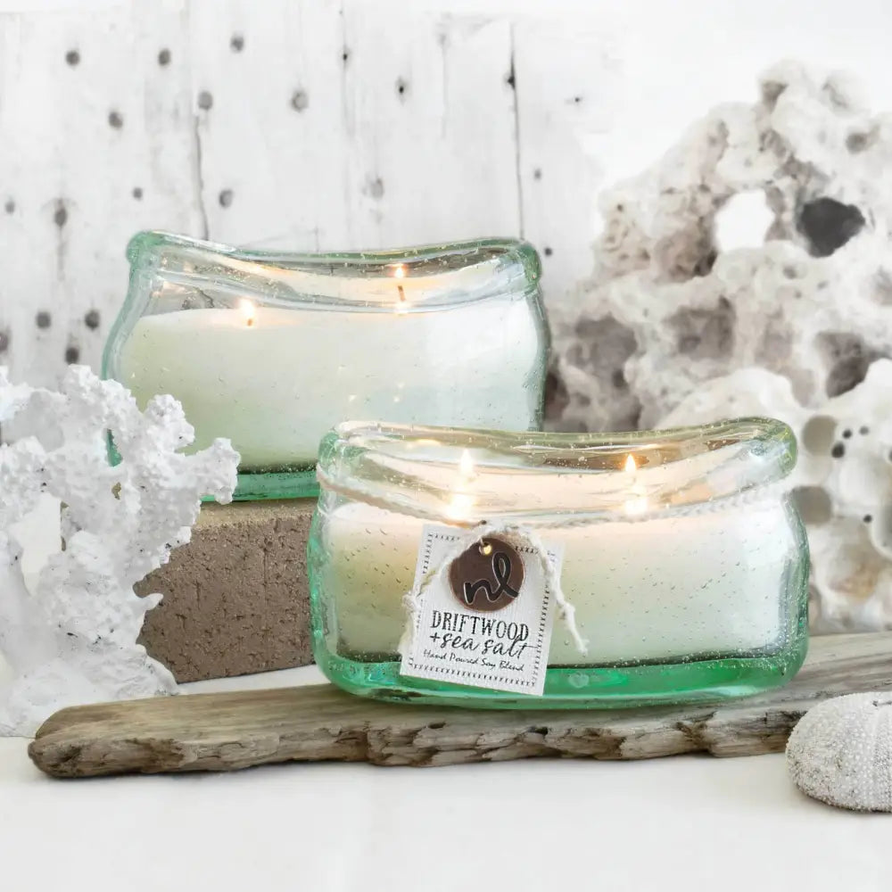 A white three-wick candle in a translucent green bubble glass container from the bubble glass candle collection with driftwood sea salt label