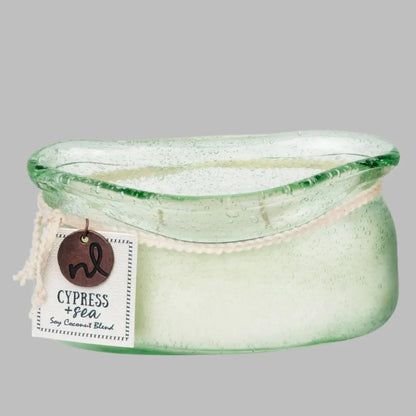 A hand-blown glass vessel with an artisan-rolled rim filled with natural candle wax with two wicks. 