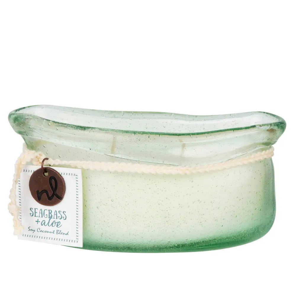 A translucent green bubble glass candle jar with frosted texture and white label from bubble glass candle collection