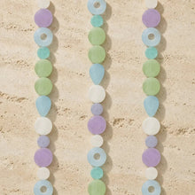 Pastel-colored capiz strand watch light dance with iridescent shells in lavender, mint green, light blue, and white beads