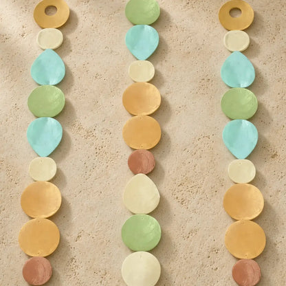 Pastel capiz strand garland with iridescent shells in mint, peach, cream, and gold lets you watch light dance