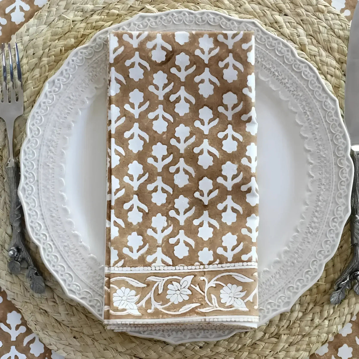 Folded tan and white floral cotton block print napkin from Caramel Block Print Napkin set