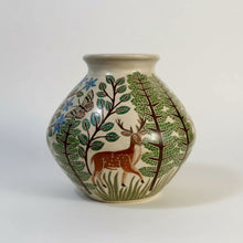 Cream-colored carved clay woodland vase with deer trees butterfly and blue flowers