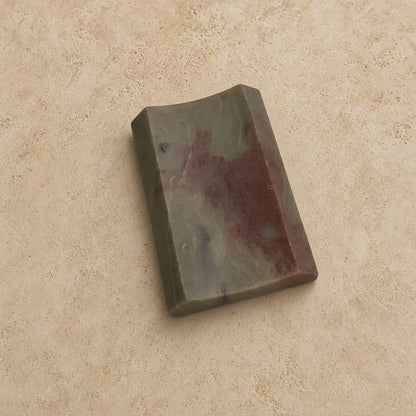 Carved soapstone rectangle concave soap dish with smooth polished jade stone featuring green and reddish brown veining