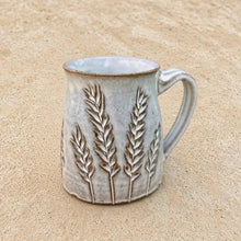 Rustic handmade pottery carved tapered mug with matte gray glaze and raised carved wheat mugs design