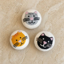 Three handcrafted wool dryer balls in gray orange and black with adorable cat designs and embroidered pink noses