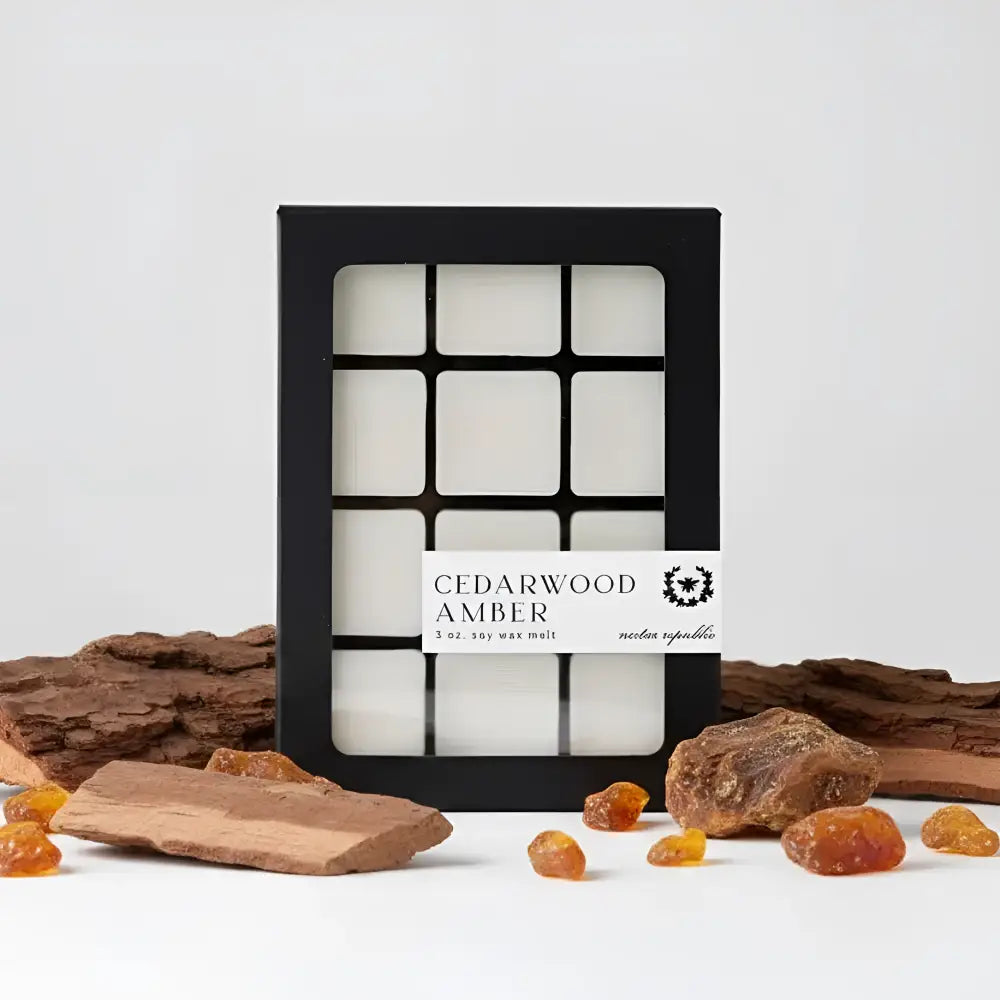 Black-framed box of twelve white soy wax melts labeled cedarwood amber by nectar republic for cozy scenting