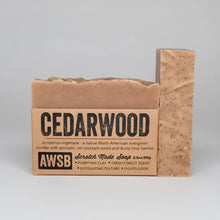 A beige cedarwood exfoliating bar soap with purifying red clay and fir needle scent for odor fighting and cleansing
