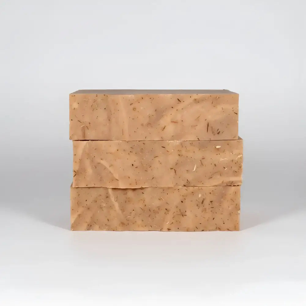 Three tan cedar wood exfoliating soap bars with red clay and fir needle for odor fighting and skin care