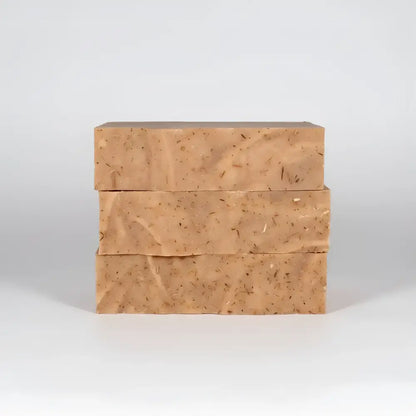 Three tan cedar wood exfoliating soap bars with red clay and fir needle for odor fighting and skin care