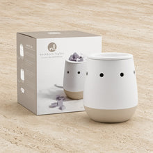 Matte white ceramic electric wax warmer with beige base and black vents perfect for favorite wax melts