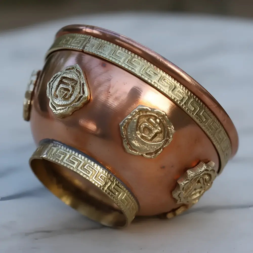 Copper-colored solid copper chakra cone incense bowl with gold geometric inlays for meditation spaces and ritual practices