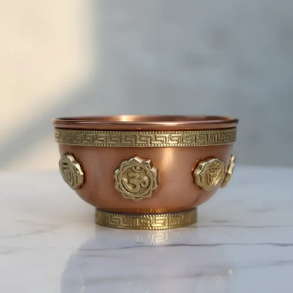 Small copper incense burner with gold om symbols ideal for meditation spaces and ritual practices in solid copper
