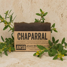 Dark brown rectangular chaparral shampoo bar soap antifungal with natural cardboard wrapper and wild chaparral leaf design