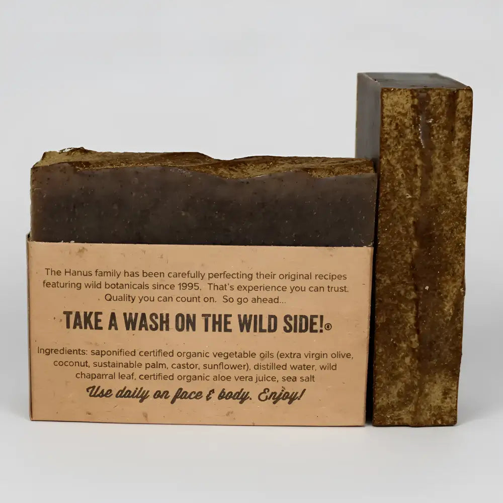 Dark brown chaparral shampoo and body bar soap with wild chaparral leaf and natural ingredients in kraft paper packaging
