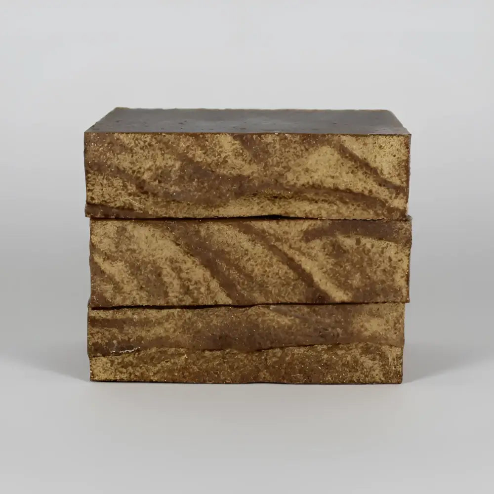 Three stacked chaparral shampoo and body bar soaps with wild chaparral leaf marbled brown and gold swirl pattern