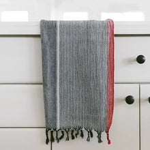 100% Turkish cotton towel that has been hand loomed in a flat weave and hand dyed in charcoal, off white and red colors.