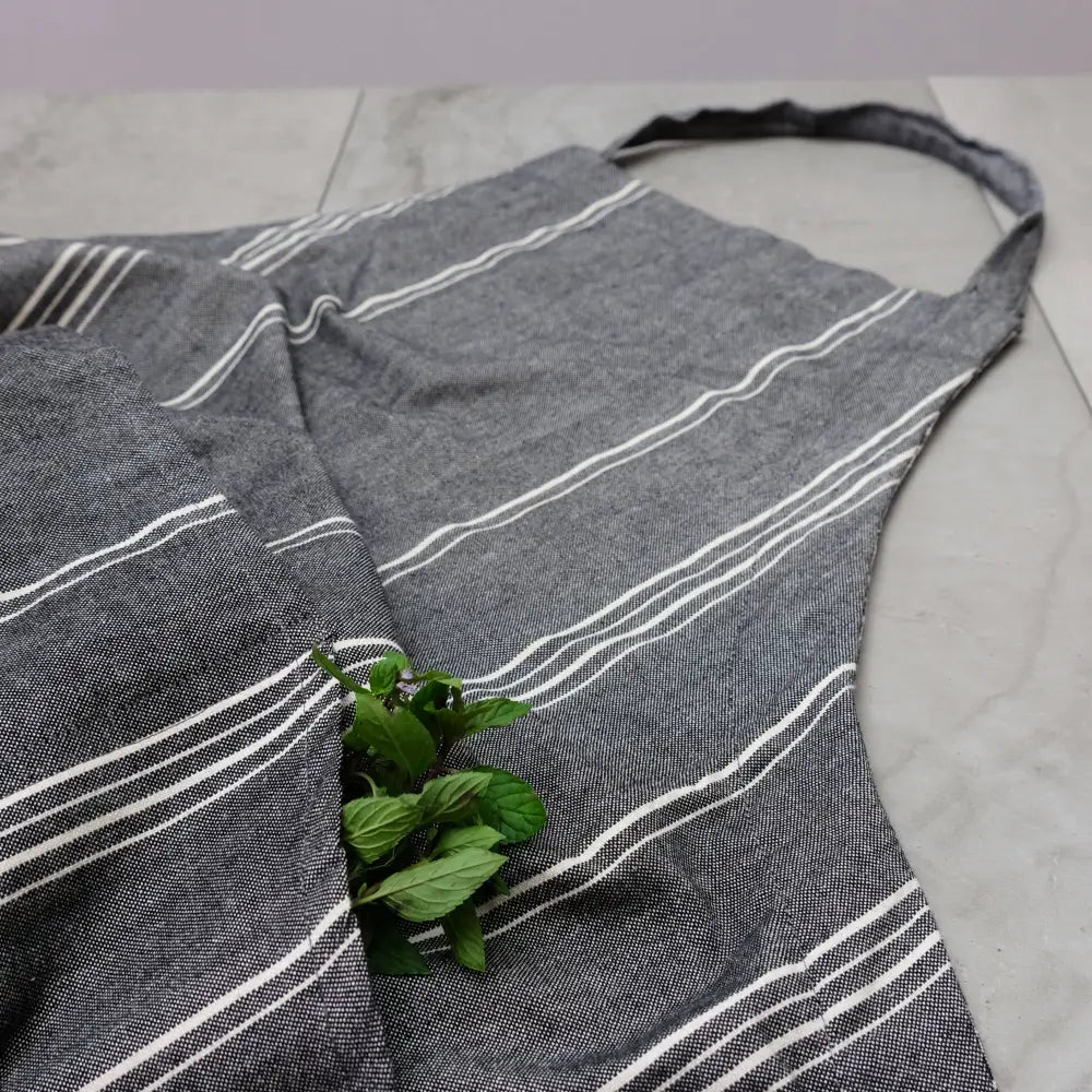 Gray striped cooking apron with mint leaves in pocket