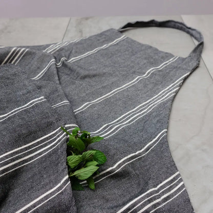 Gray striped cooking apron with mint leaves in pocket