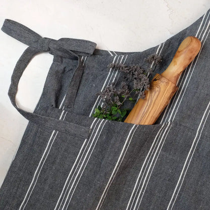 Charcoal gray handmade cooking apron with white stripes, spoon and herbs
