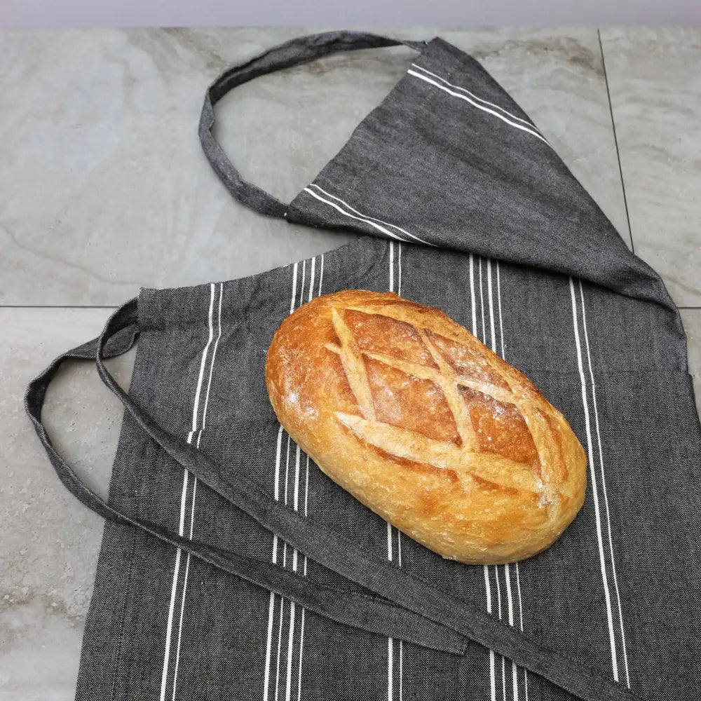 Charcoal gray handmade cooking apron with white stripes and bread