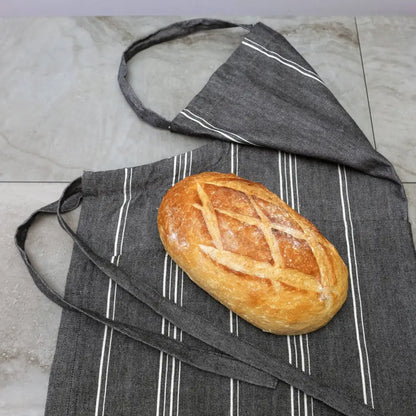 Charcoal gray handmade cooking apron with white stripes and bread