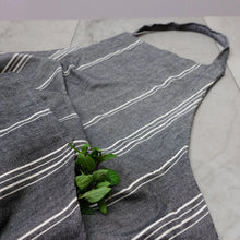 Gray striped cooking apron with mint leaves in pocket