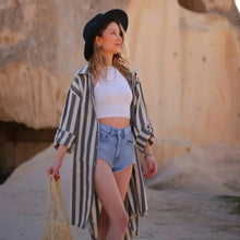Woman in a black hat and striped linen cotton blend shirt dress cover up