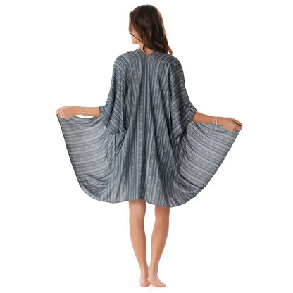 A flowing charcoal tribal print kimono cover-up with dark gray and white stripes and loose wide sleeves