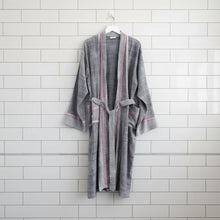 Gray and pink striped Charcoal Tribeca Long Bathrobe hanging on a white hook