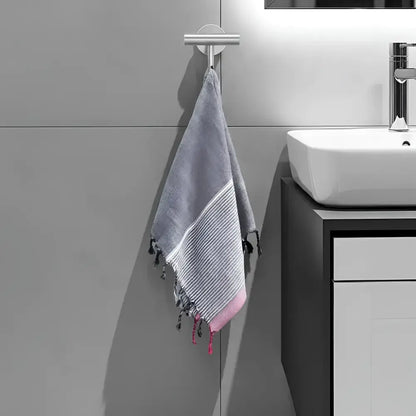 Gray and pink striped turkish cotton towel with tassels hanging from silver hook ruby striped turkish style