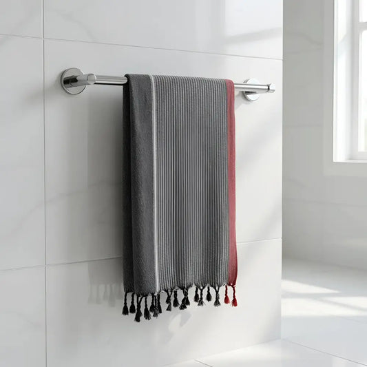Charcoal white and ruby striped turkish hand towel with gray and red stripes and black tassels hanging on chrome rack