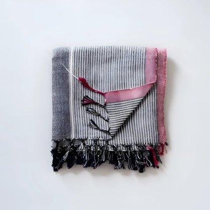 Folded Charcoal and Ruby Striped Turkish Bath Towel made from Turkish cotton with tassels