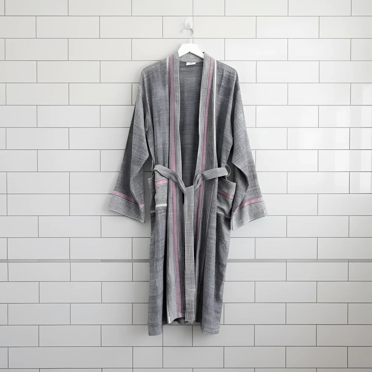 A soft gray bathrobe with ruby striped turkish towel colors, ribbed cuffs, and matching belt made of turkish cotton